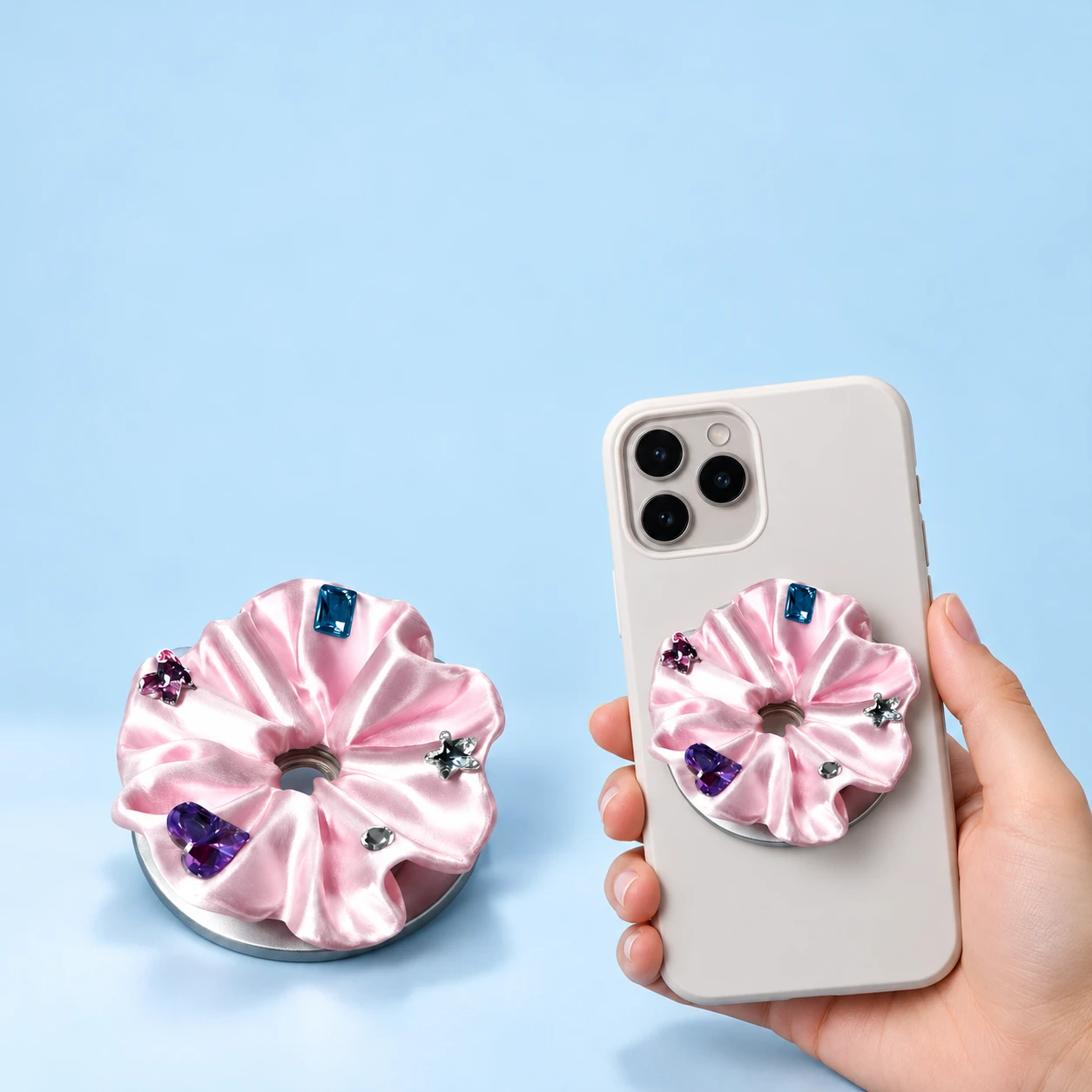 Pink ruffled magnetic phone grip with decorative faceted accents shown complete and mounted flat on a phone case, square composition