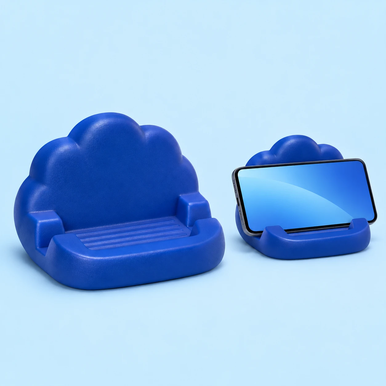 Blue one-piece PU foam cloud phone cradle, with an illustrative landscape-phone resting view; phone not included, square composition