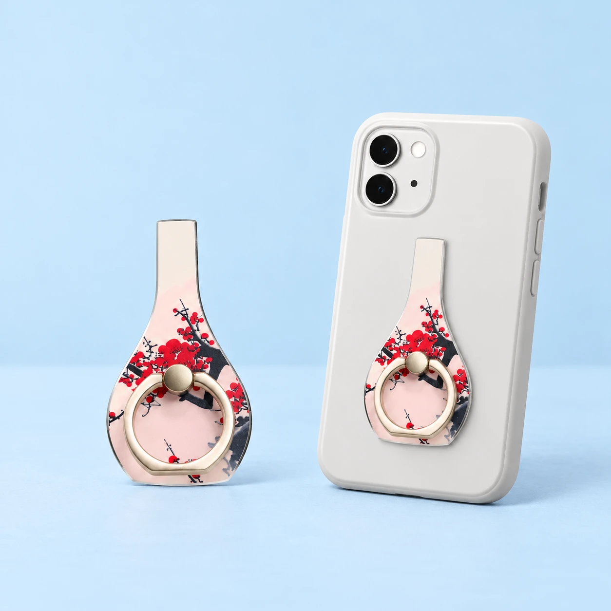 Blush plum-blossom vase phone ring holder with gold-tone hinged ring and conservative closed phone-back placement, square composition