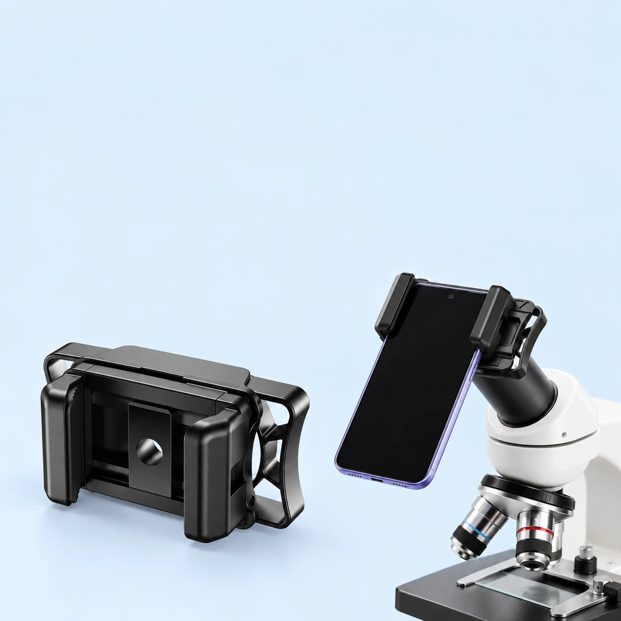 Complete empty black compact-frame optical phone adapter at left; the same original jaws hold a demonstration phone on a microscope eyepiece at right against pale blue. Phone and microscope not included., square composition