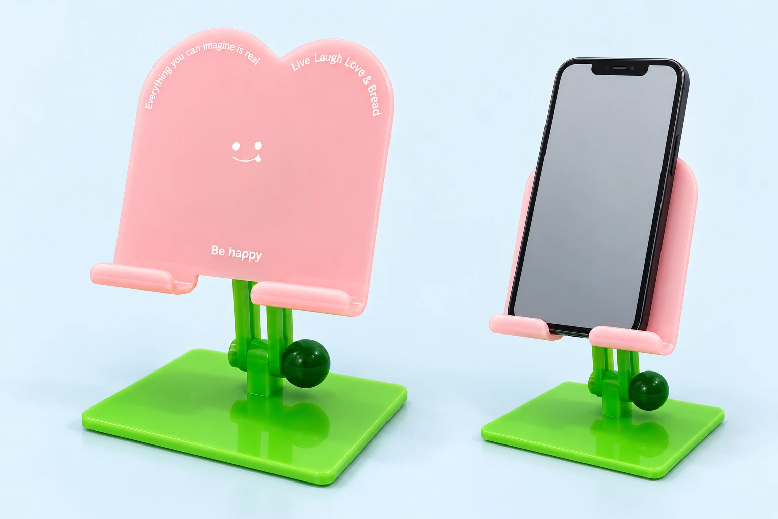 Pink twin-lobe smiling phone stand with green twin-rail support and portrait phone illustration