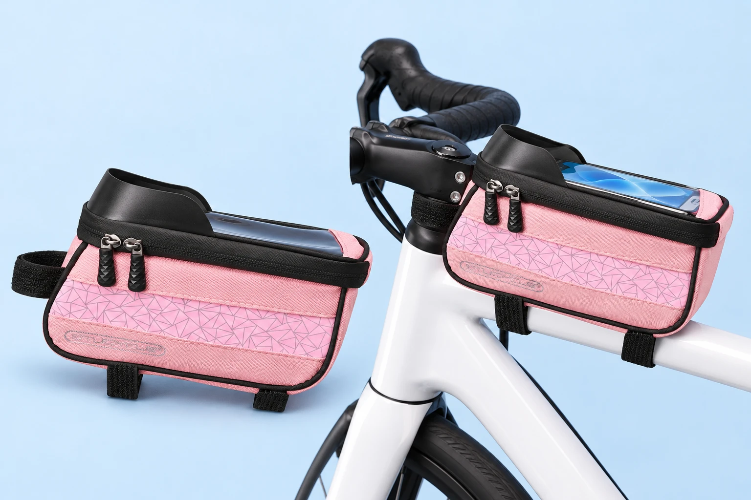 Complete pink geometric top-tube phone-window bag with its three original black wraps at left, and the same bag with a demonstration phone on a stationary white bicycle top tube at right, on a pale-blue background.