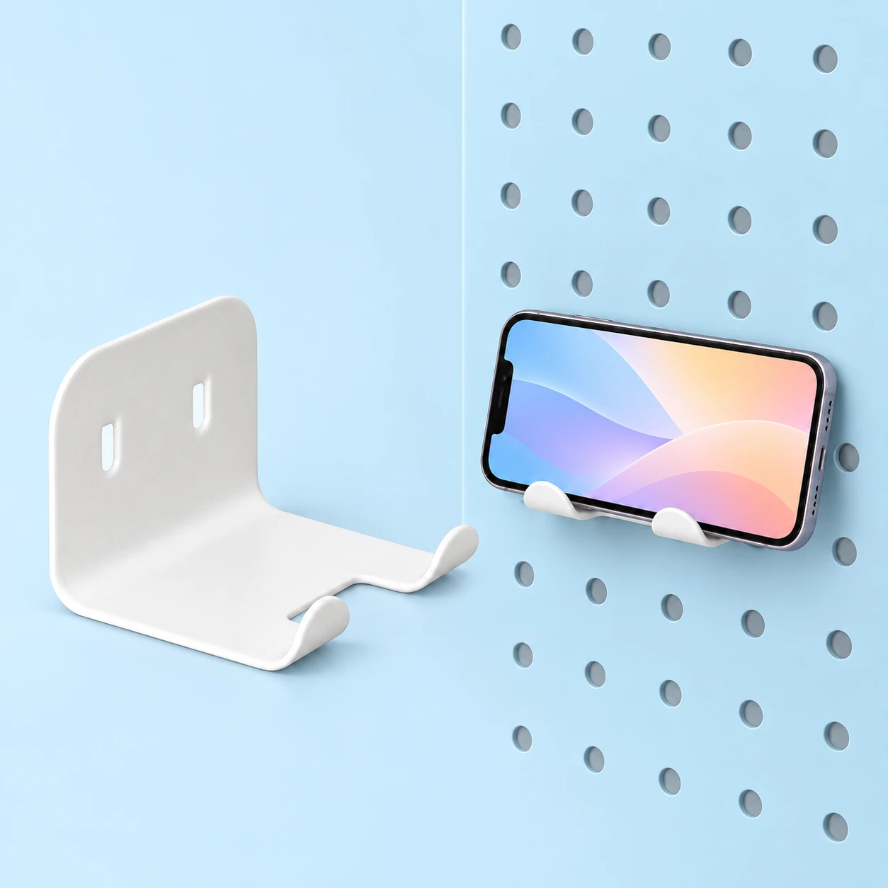 White Single Pegboard Phone Cradle; product and illustrative use on pale blue. Phone and scene props excluded., square composition