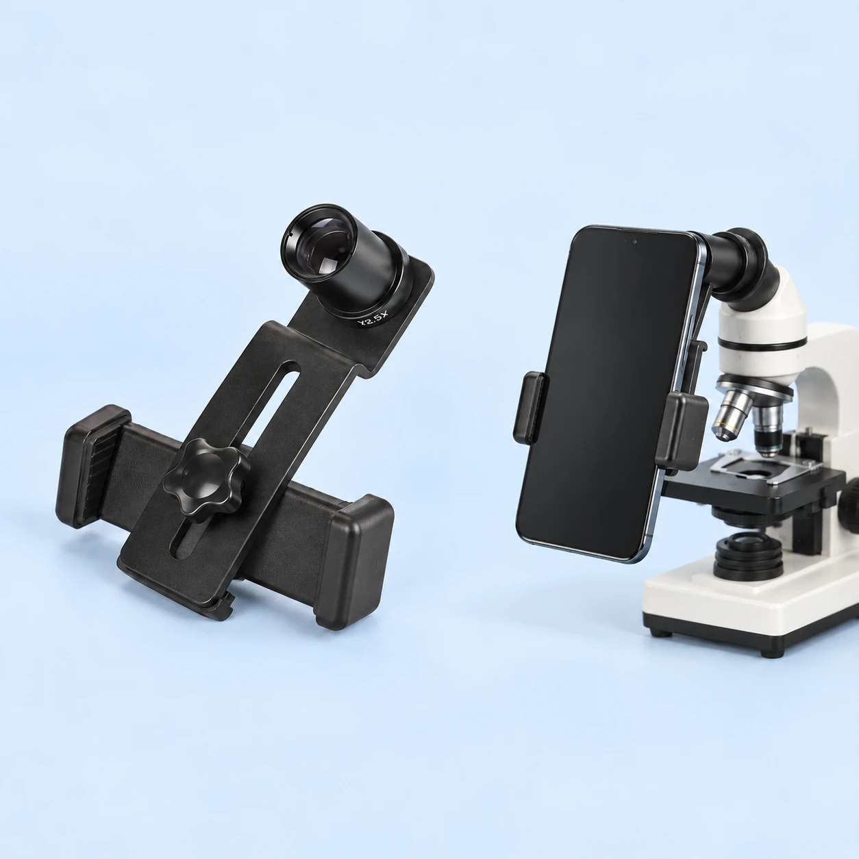 Complete black slotted-plate microscope phone adapter with its original threaded eyepiece at left, and the same original jaws holding a portrait demonstration phone at a stationary tabletop microscope at right on pale blue. Phone and microscope are not included., square composition
