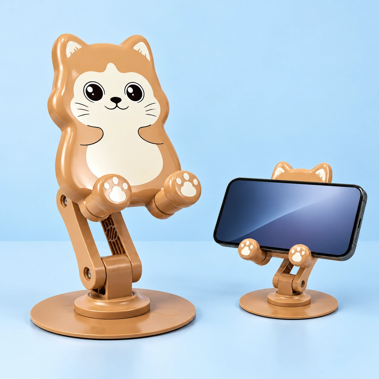 Tan cat rotating folding phone stand, complete stand left and landscape phone in paw-shaped cradle right; phone not included