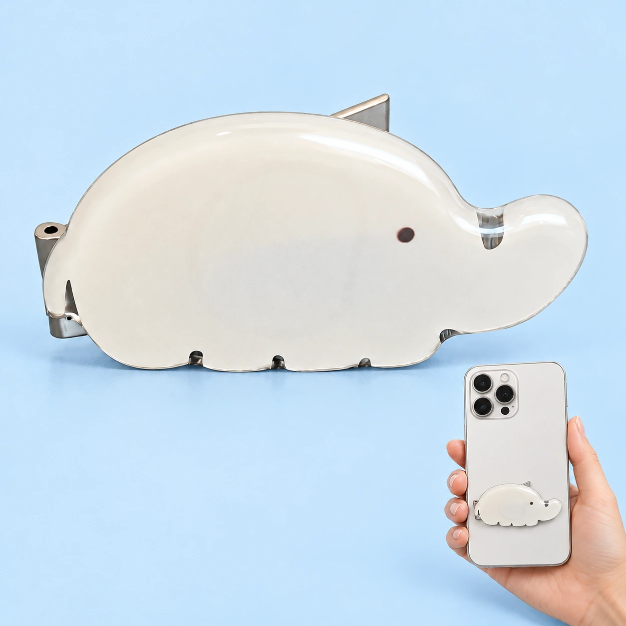 Pale elephant folding phone kickstand shown complete and mounted on a phone