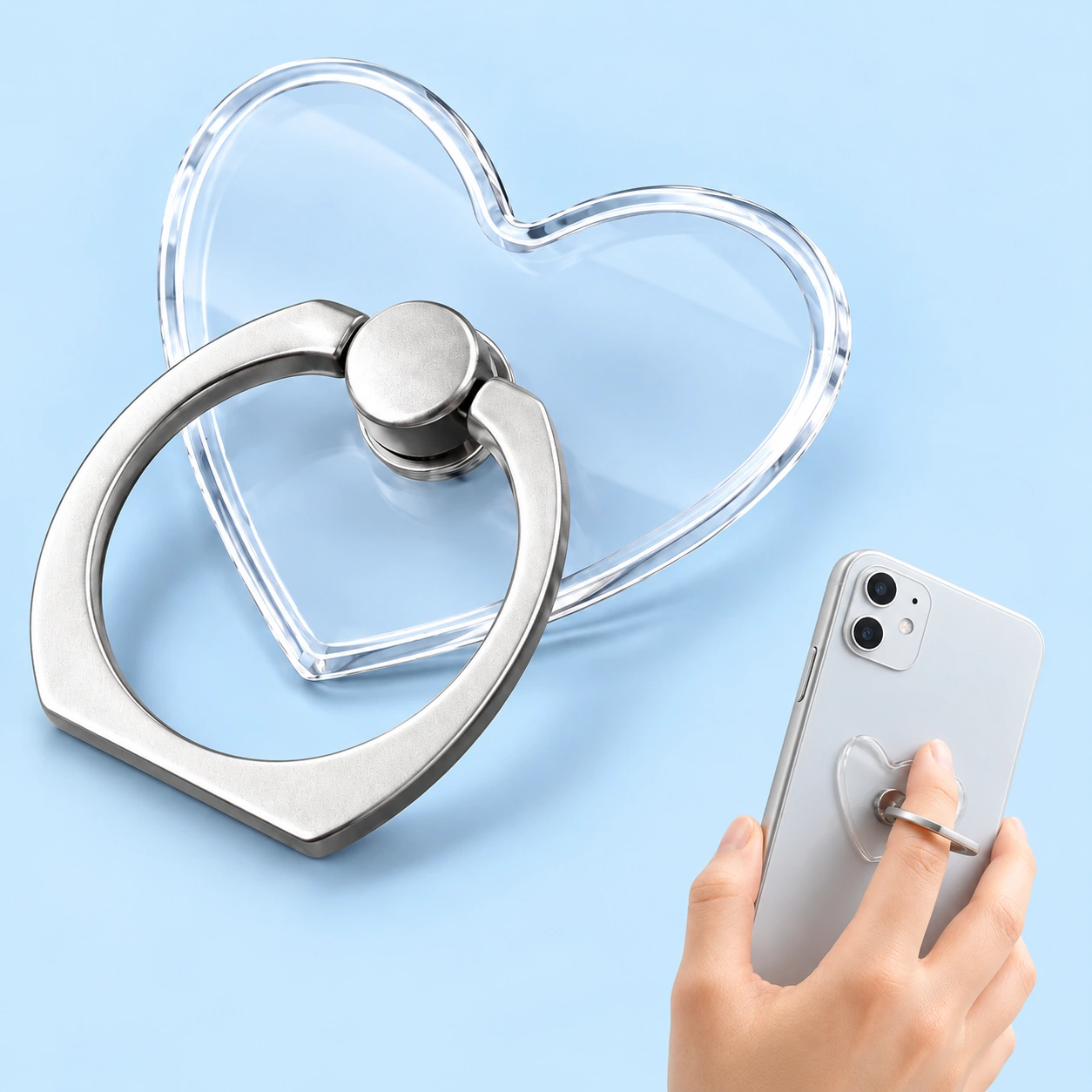 Clear heart-shaped phone ring holder shown complete and in finger-grip use