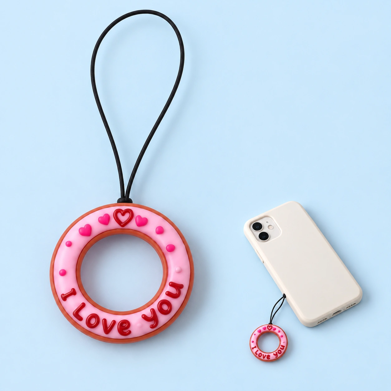 Pink lettered donut finger-loop phone lanyard and case-hole attachment illustration