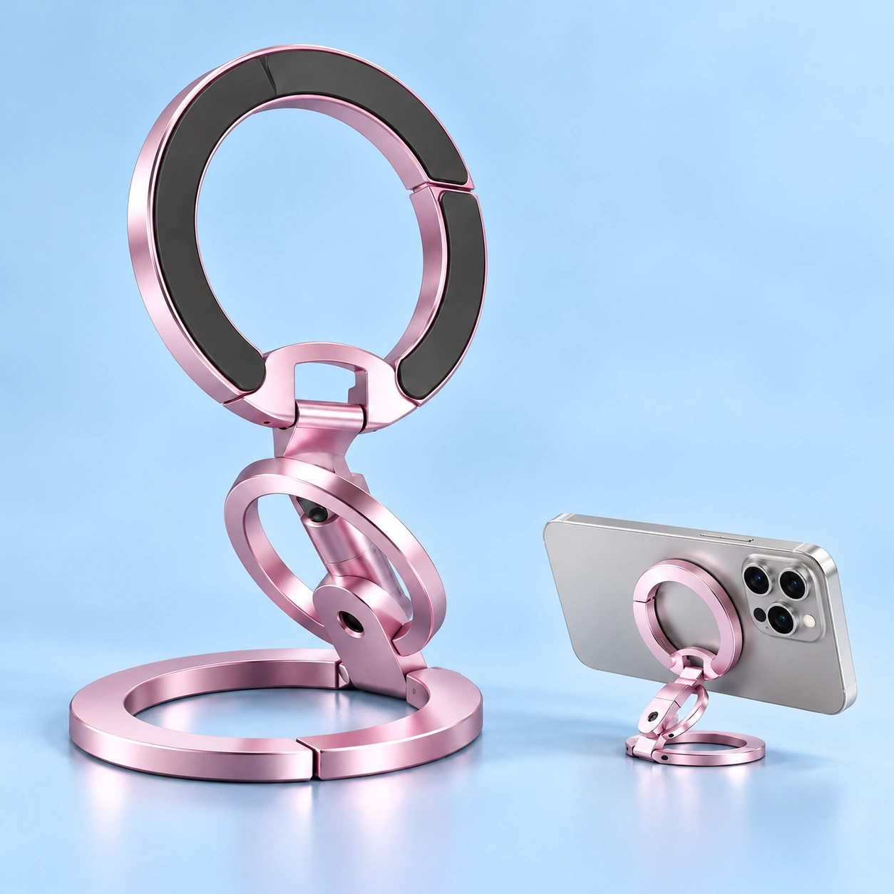 Cherry blossom pink dual-ring folding magnetic phone stand, with illustrative landscape phone use