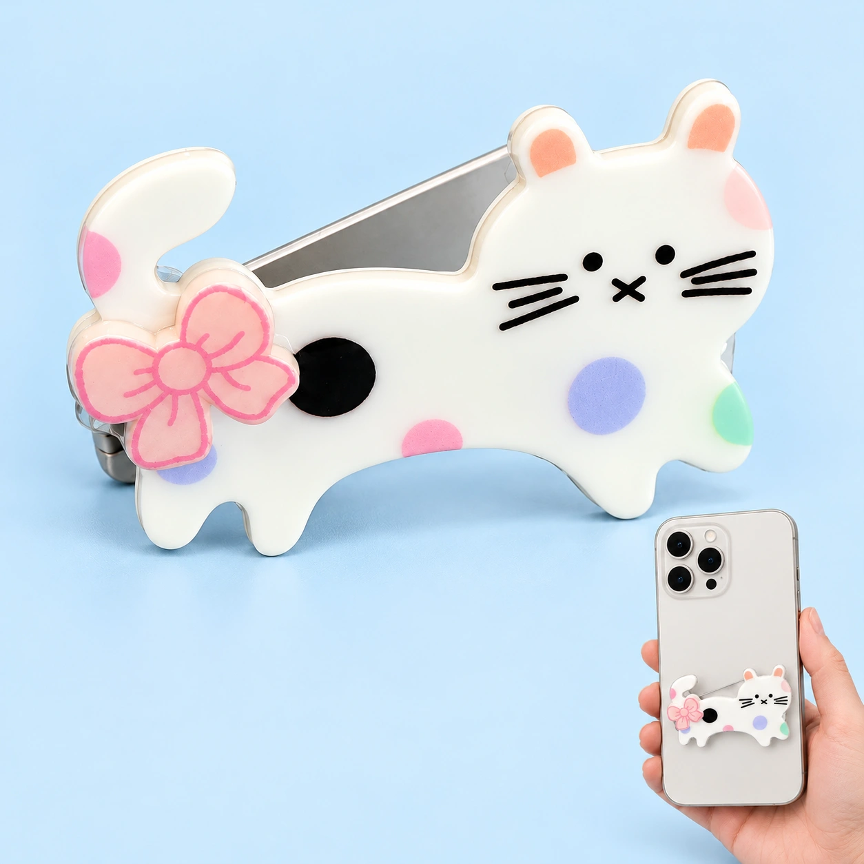 Tail-bow cat folding phone kickstand shown complete and mounted on a phone