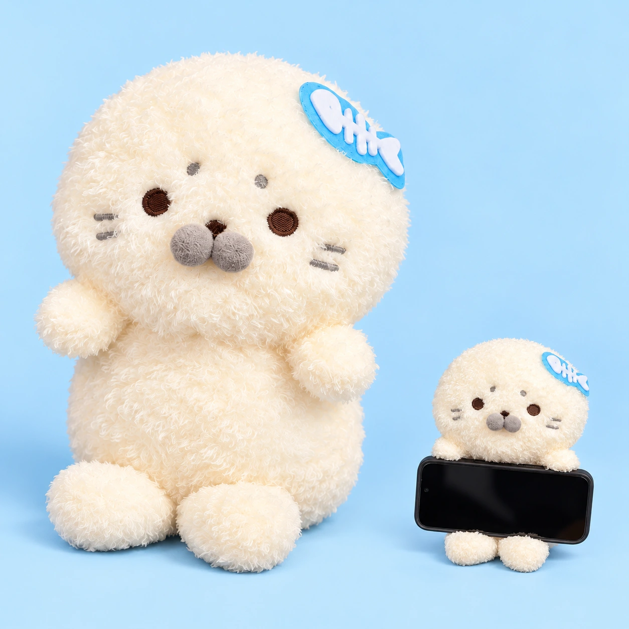 Cream plush seal pillow phone stand and illustrative landscape-phone support