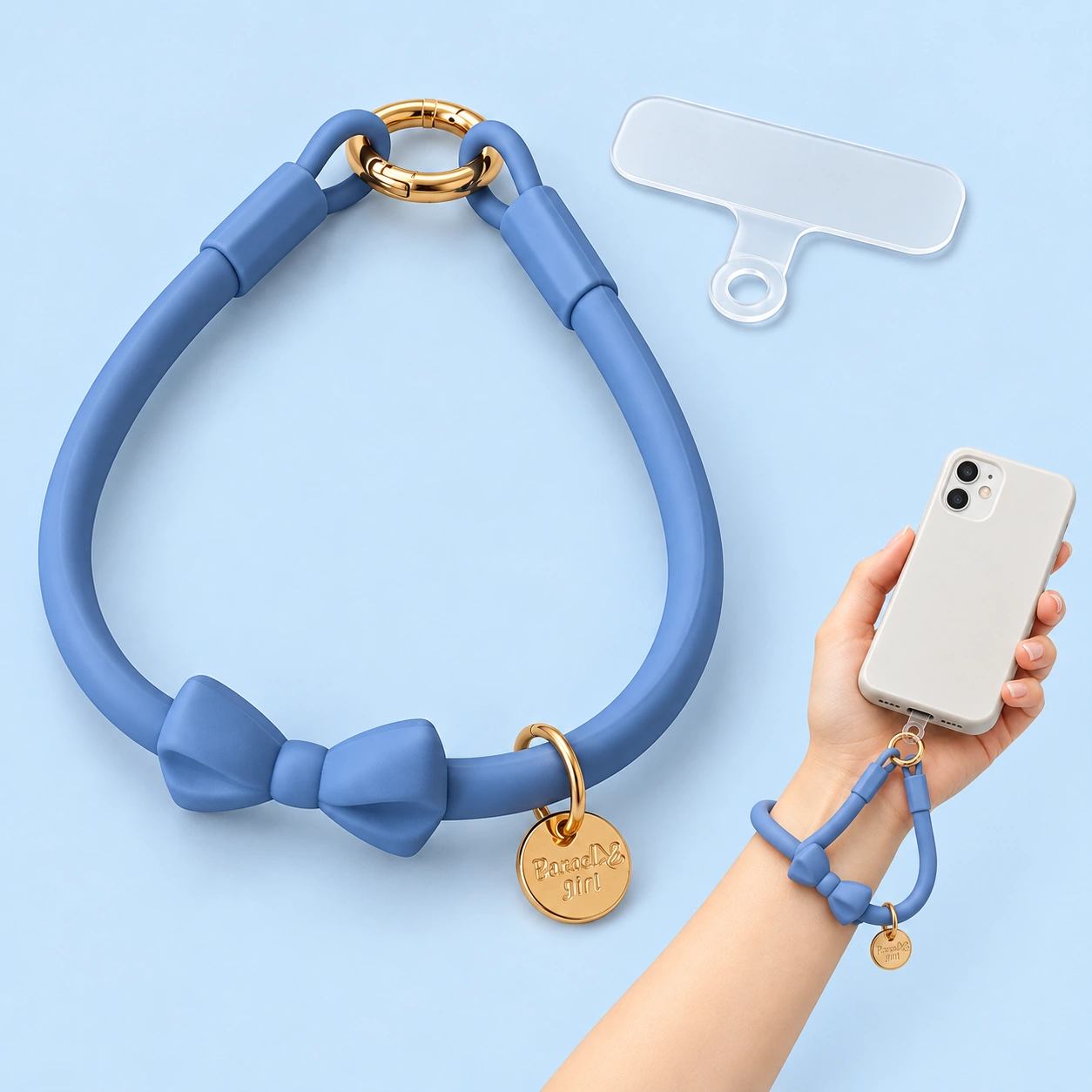 Blue bow silicone wrist phone lanyard shown complete with a tether tab and connected to a held phone