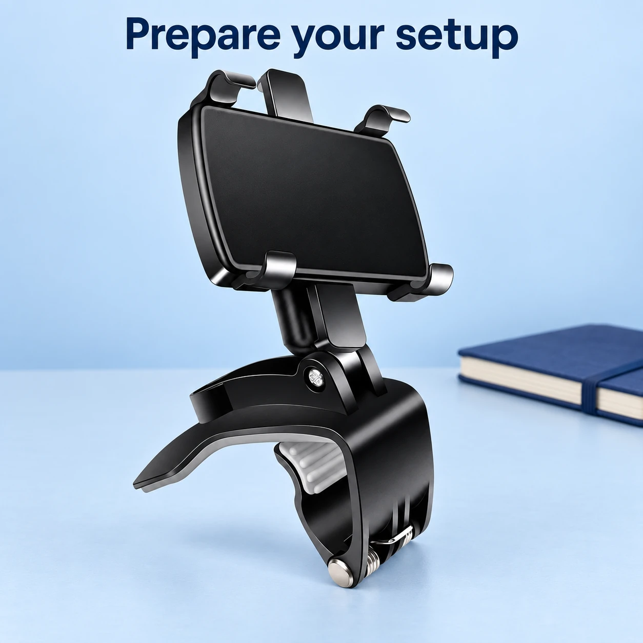 Empty rear view mirror phone holder on a dry preparation table beside a notebook