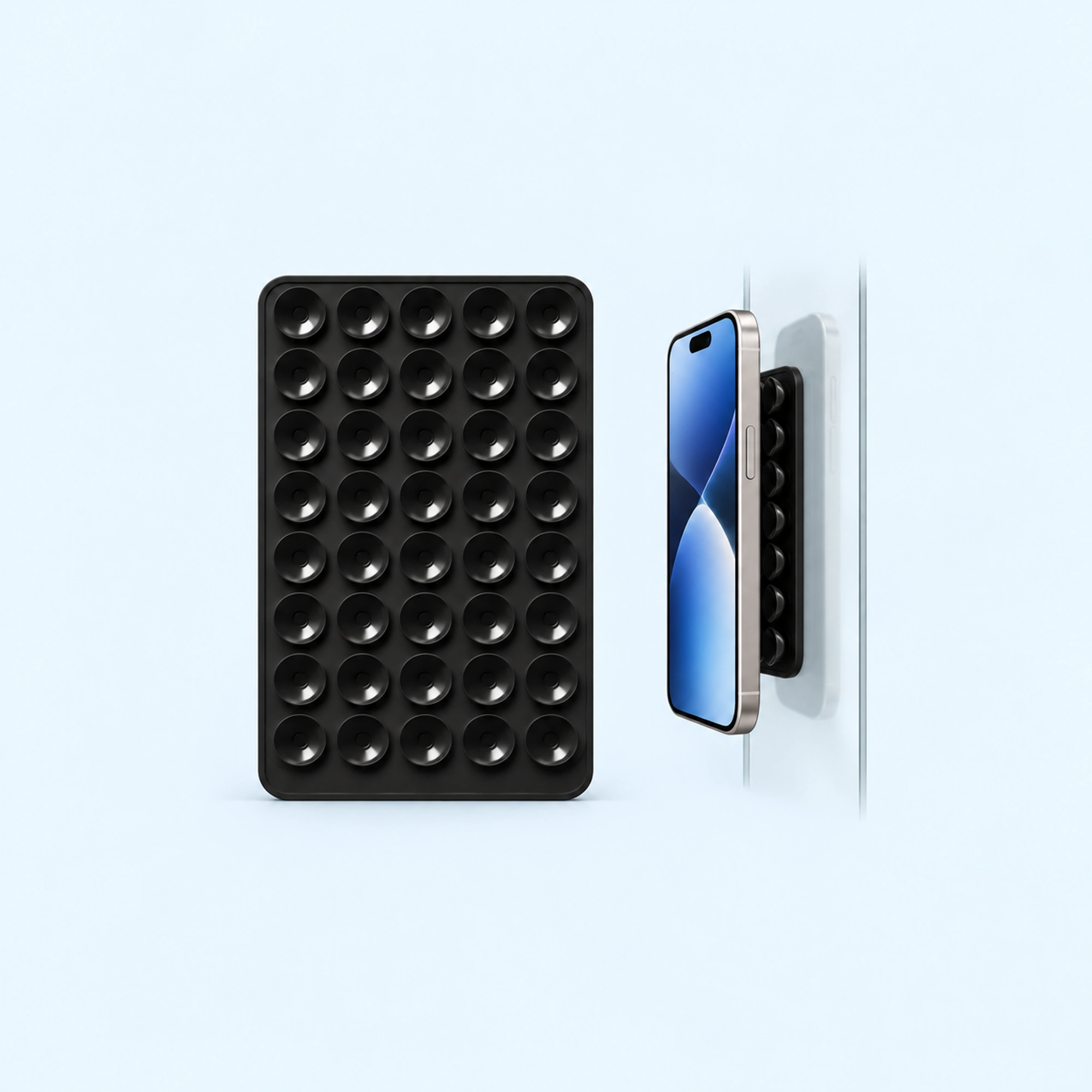 Black Double-Sided Silicone Suction Phone Holder — complete product with example of use on pale blue background