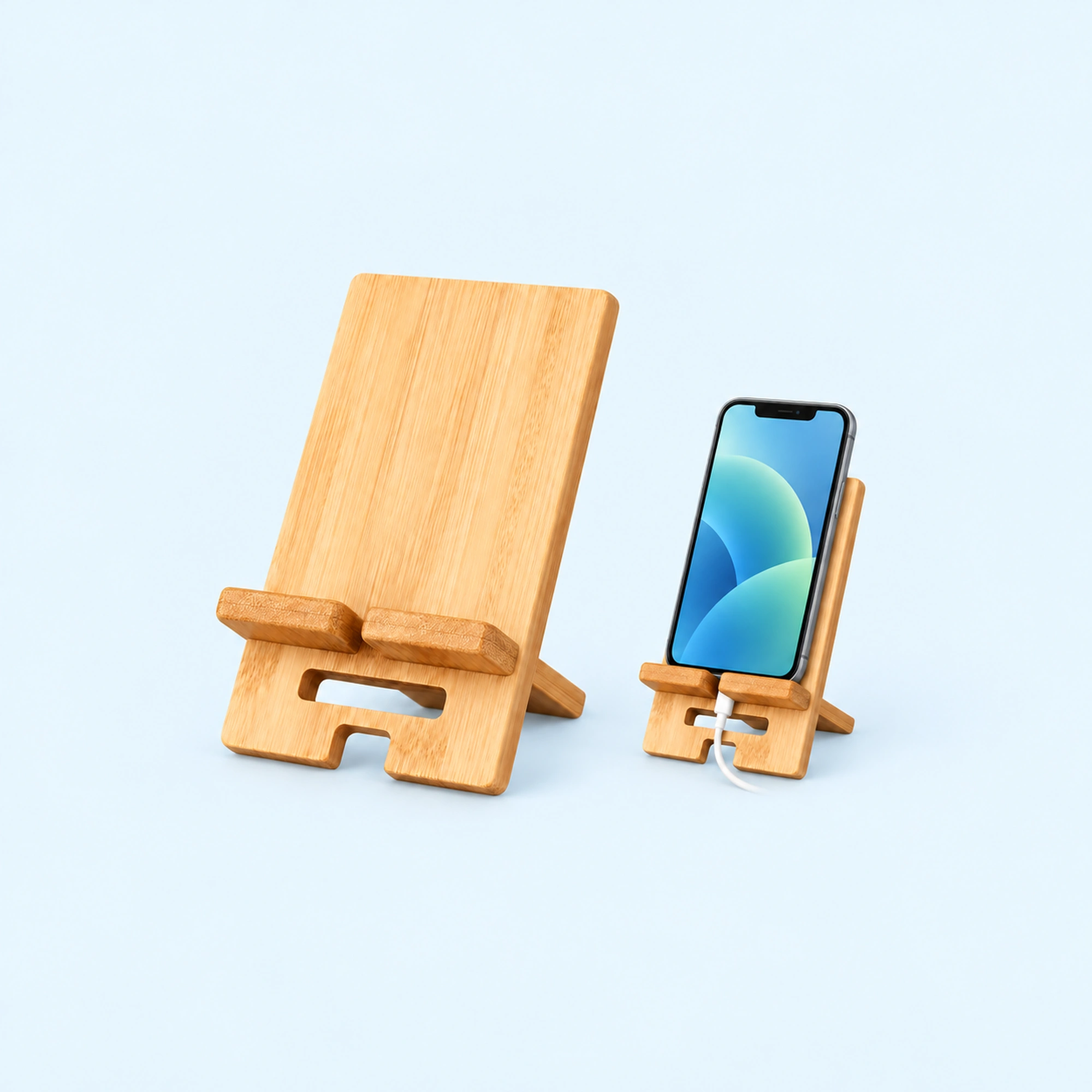 Bamboo Desk Phone Stand with Charging Cutout — complete product with example of use on pale blue background